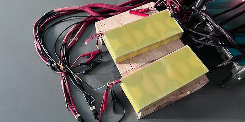Battery engineer performing quality inspection and aging test on 36V robot battery pack at Himax Electronics manufacturing facility