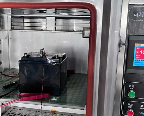 12.8V 40Ah LiFePO4 emergency lighting battery undergoing 100°C high-temperature discharge test at 97.5W for 35 minutes inside a constant-temperature-and-humidity chamber