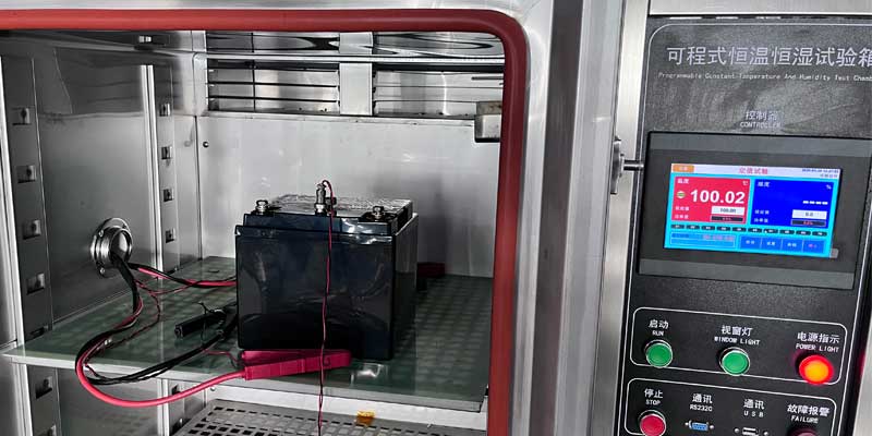 12.8V 40Ah LiFePO4 emergency lighting battery undergoing 100°C high-temperature discharge test at 97.5W for 35 minutes inside a constant-temperature-and-humidity chamber