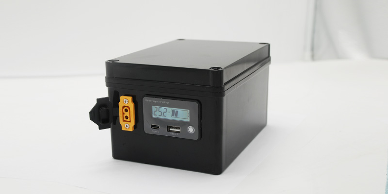 Completed 25.6V 10Ah LiFePO4 battery pack in black ABS housing — a direct lead-acid replacement for electric walkers, featuring RS485 smart BMS, Reach and RoHS certification for North American OEM customers