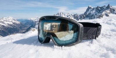 High-tech AI ski goggles resting on alpine snow background