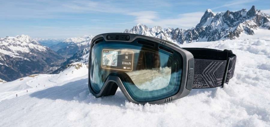 High-tech AI ski goggles resting on alpine snow background